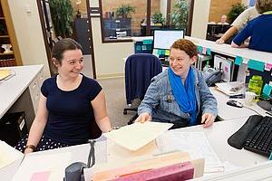 smiling student workers in an office